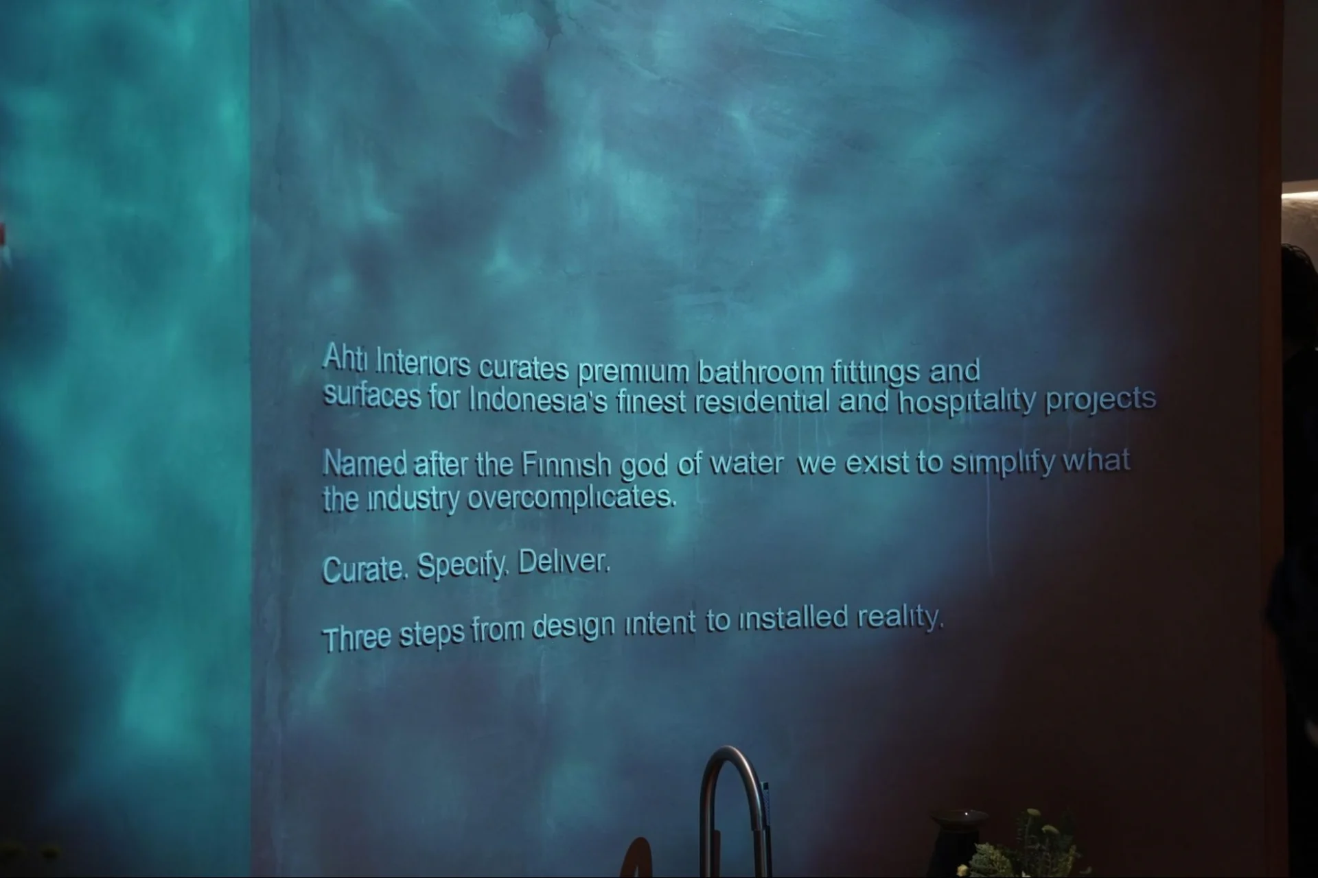 Ahti Interiors text on blue textured wall